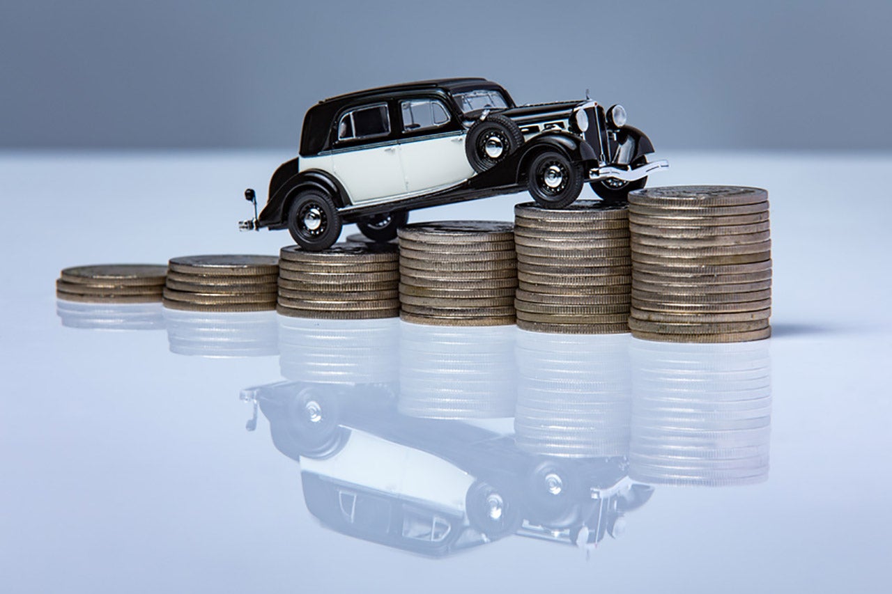 Toy car climbing up a stack of coins | Vehicle Financing